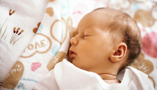 newborn baby sleeping in the crib on a blanket.the photo has a empty space for your text