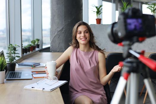 Beautiful young woman talking and smiling while making new video for her blog