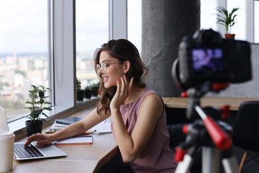 Beautiful young woman talking and smiling while making new video for her blog