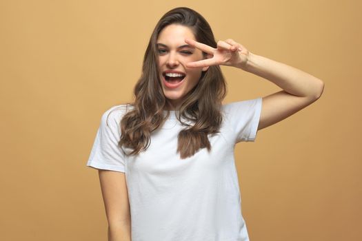 Portrait of young beautiful cheerful girl smiling looking at camera over gray background