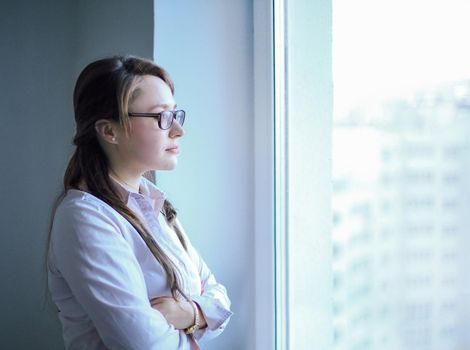 Executive business woman looking out the office window.photo with copy space