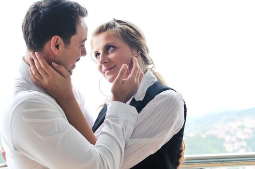 romantic happy couple relax and have fun at balcony in their new home apartment