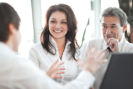 closeup. business team talking while sitting at your Desk in the office