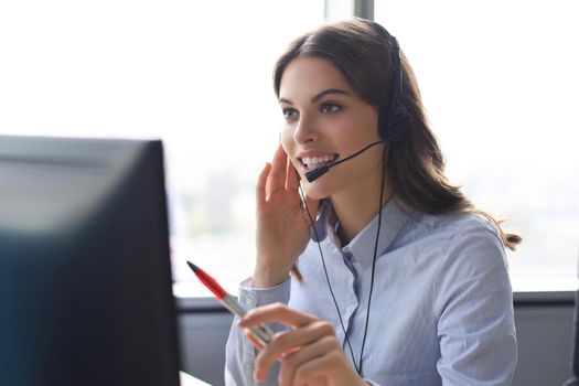 Woman customer support operator with headset and smiling