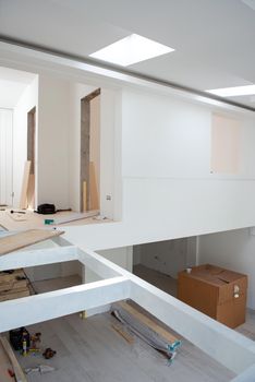 Interior of unfinished stylish modern open space two level apartment with white walls soon ready to move in