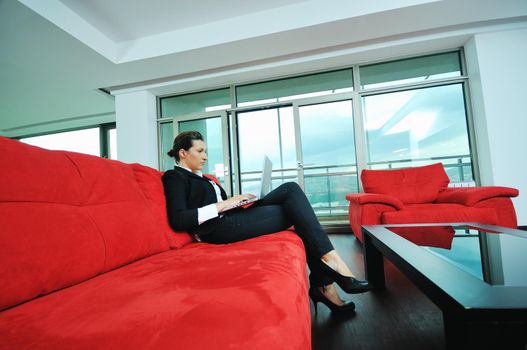 young business woman working on laptop at home in confort bright apartment 