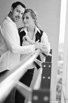 romantic happy couple relax and have fun at balcony in their new home apartment