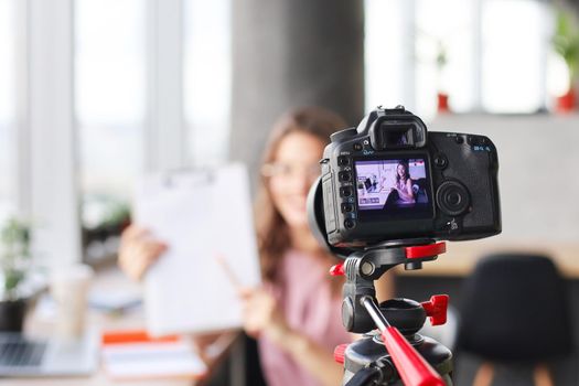 Beautiful young woman talking and smiling while making new video for her blog