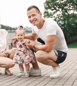 cute little baby girl on walk with parent, first steps.