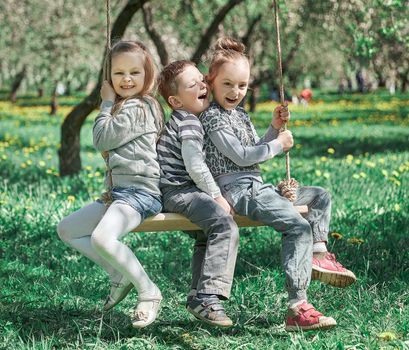 mom with her three children resting in the summer Park . the concept of joint recreation