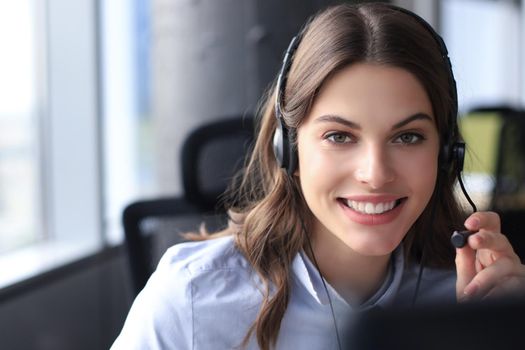 Female customer support operator with headset and smiling