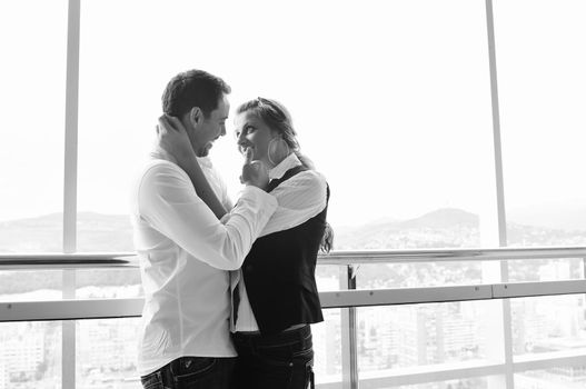 romantic happy couple relax and have fun at balcony in their new home apartment