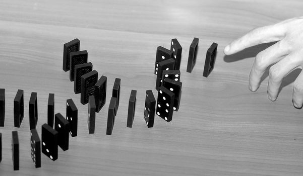 close up. businessman touching Domino with his finger.