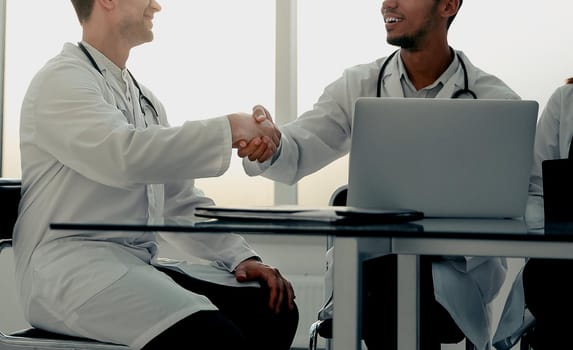 bottom view.handshake of medical colleagues at a meeting in the office. concept of cooperation