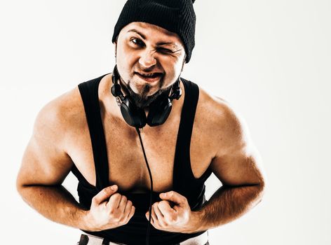 rapper with narrowed eyes with headphones on a white background.