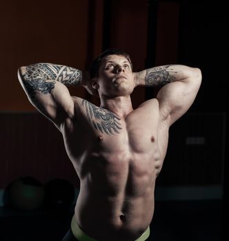 muscular bodybuilder handsome men doing exercises in gym naked torso fitness and bodybuilding.photo with copy space.