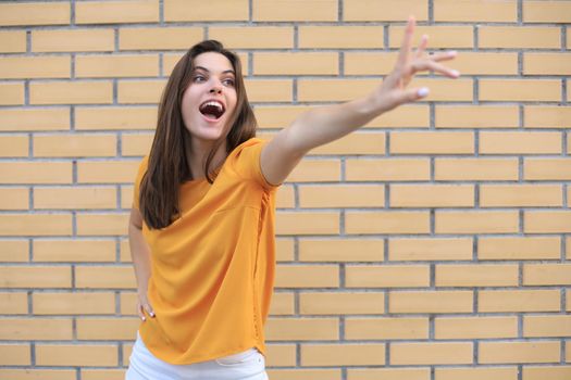Beautiful smiling brunette model dressed in summer hipster clothes. Funny and positive woman having fun