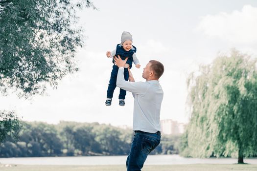 loving father playing with his son outdoors. the concept of parenting