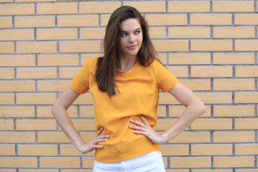 Beautiful smiling brunette model dressed in summer hipster clothes. Funny and positive woman having fun