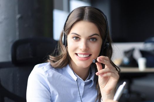 Female customer support operator with headset and smiling