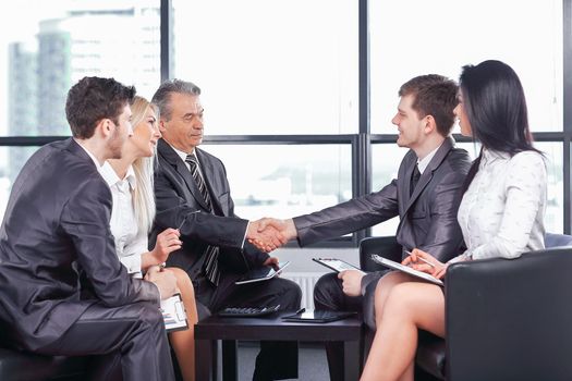 business handshake at a working meeting in the office .the concept of cooperation