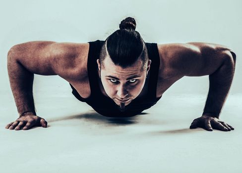 coach bodybuilding performs push-UPS.the photo has a empty space for your text
