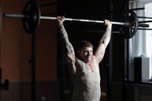 male bodybuilder doing exercises with a barbell .photo with copy space