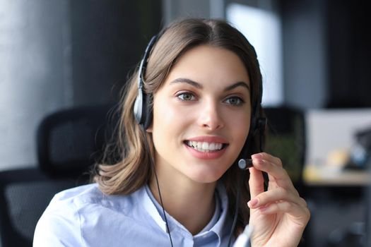 Female customer support operator with headset and smiling
