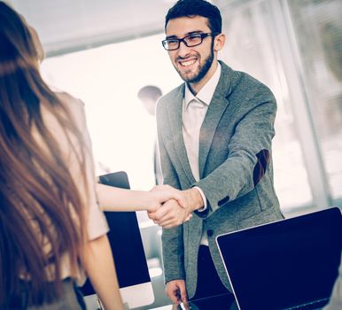 closeup - the lawyer and the client, shake hands after signing the financing contract.the photo has a empty space for your text.