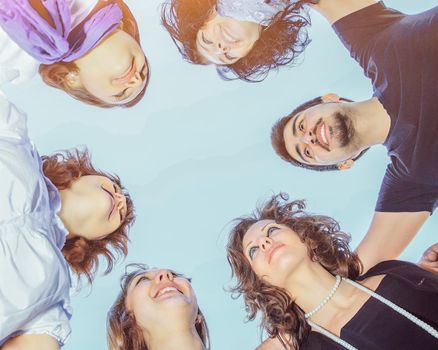 group of young students in a circle on the sky looking at each other