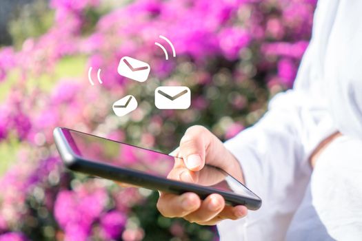 Woman hand using smartphone and it's show email recieve notification icon pop up on screen of mobile phone. Business communication  technology concept.