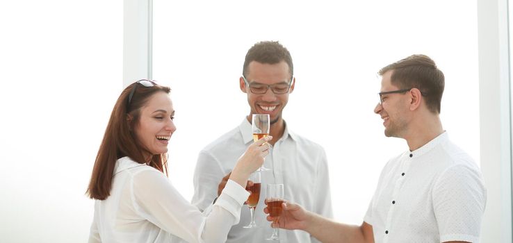close up.business team clinking glasses of wine. the concept of a successful startup