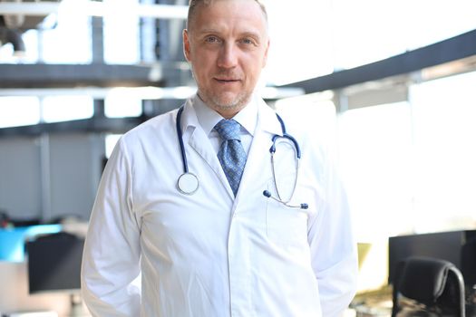 Senior chief physician in white robe with stethoscope