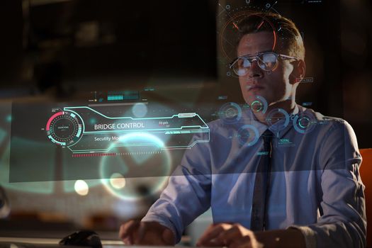 Young man working on computer at night in dark office. The designer works in the later time.