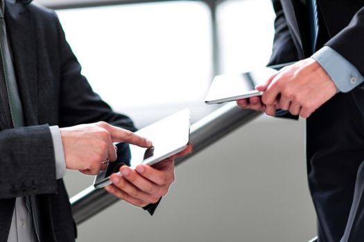 two businessmen with tablet computers.