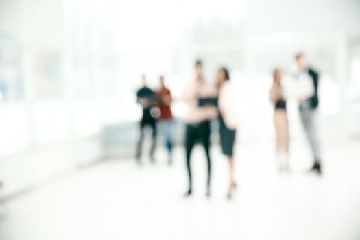 blurred image of a group of business people talking in the office lobby. photo with copy space.