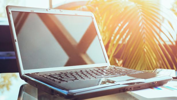 Closeup photo of laptop computer with open top. Blank screen