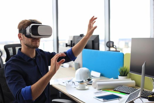 Shot of an engineer wearing a VR headset in an new building. Change the way you see and experience the world