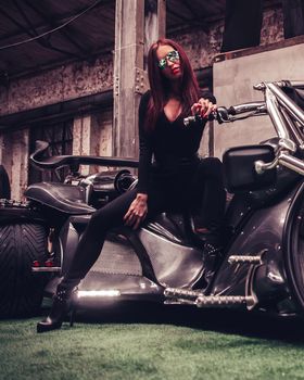 fashionable young woman posing sitting on new trike. photo with copy space