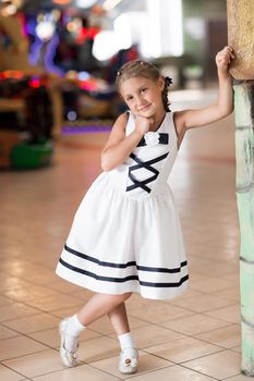 portrait of happy girl on the background of children's cafe.holiday concept