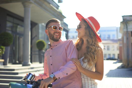 Young couple in love riding a motorbike. Riders enjoying themselves on trip. Adventure and vacations concept