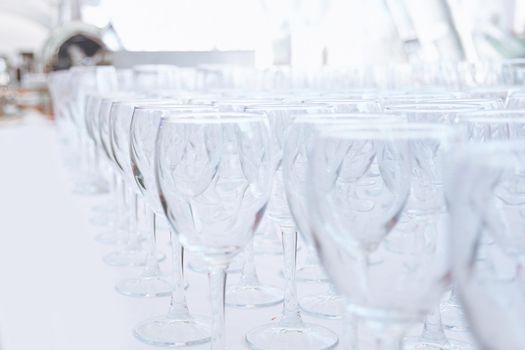 empty glass glasses on the table in the restaurant . festive reception