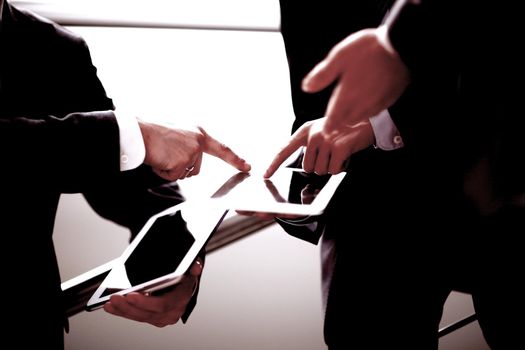 Hands of people working with tablet computer. Technology.