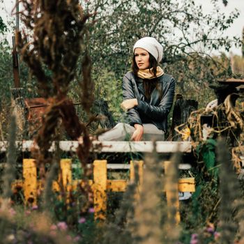 cute girl resting near the house on a warm autumn day.