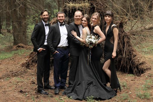 participants of the wedding ceremony on the background of the forest.