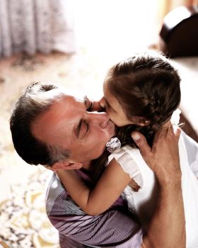 closeup.happy little girl hugging her father.