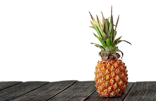 Pineapple stands on wooden boards isolated on white background