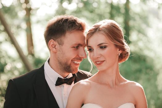 close up. beautiful portrait of the newlyweds on the background of the spring Park.