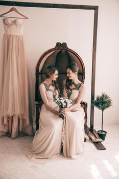 bridesmaid with a wedding bouquet sitting in a vintage chair. photo with copy space