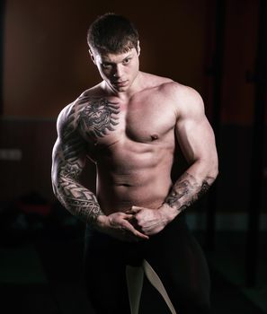 portrait of handsome male bodybuilder on dark background.photo with copy space.